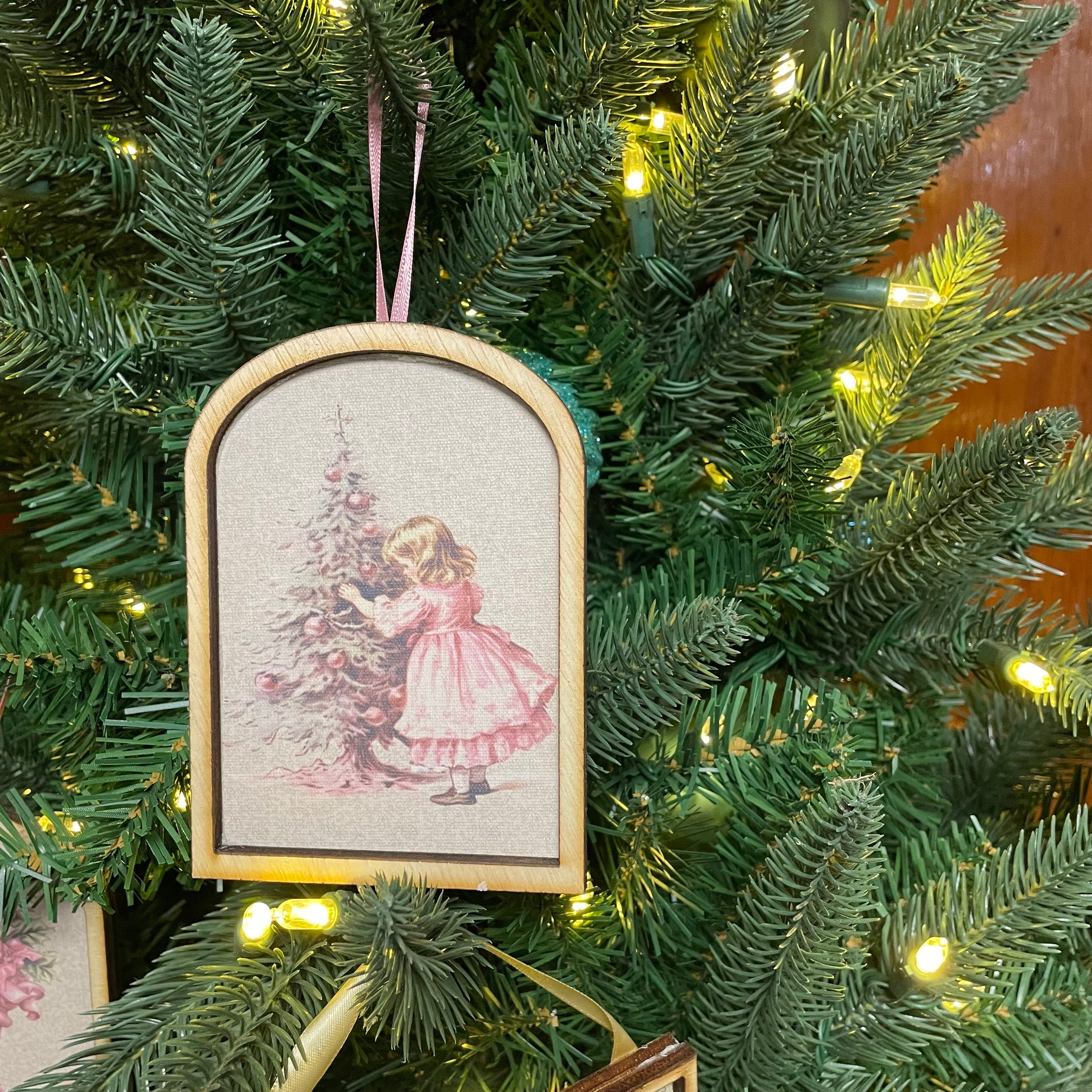 Child in Pink dress decorating tree Arched Ornament