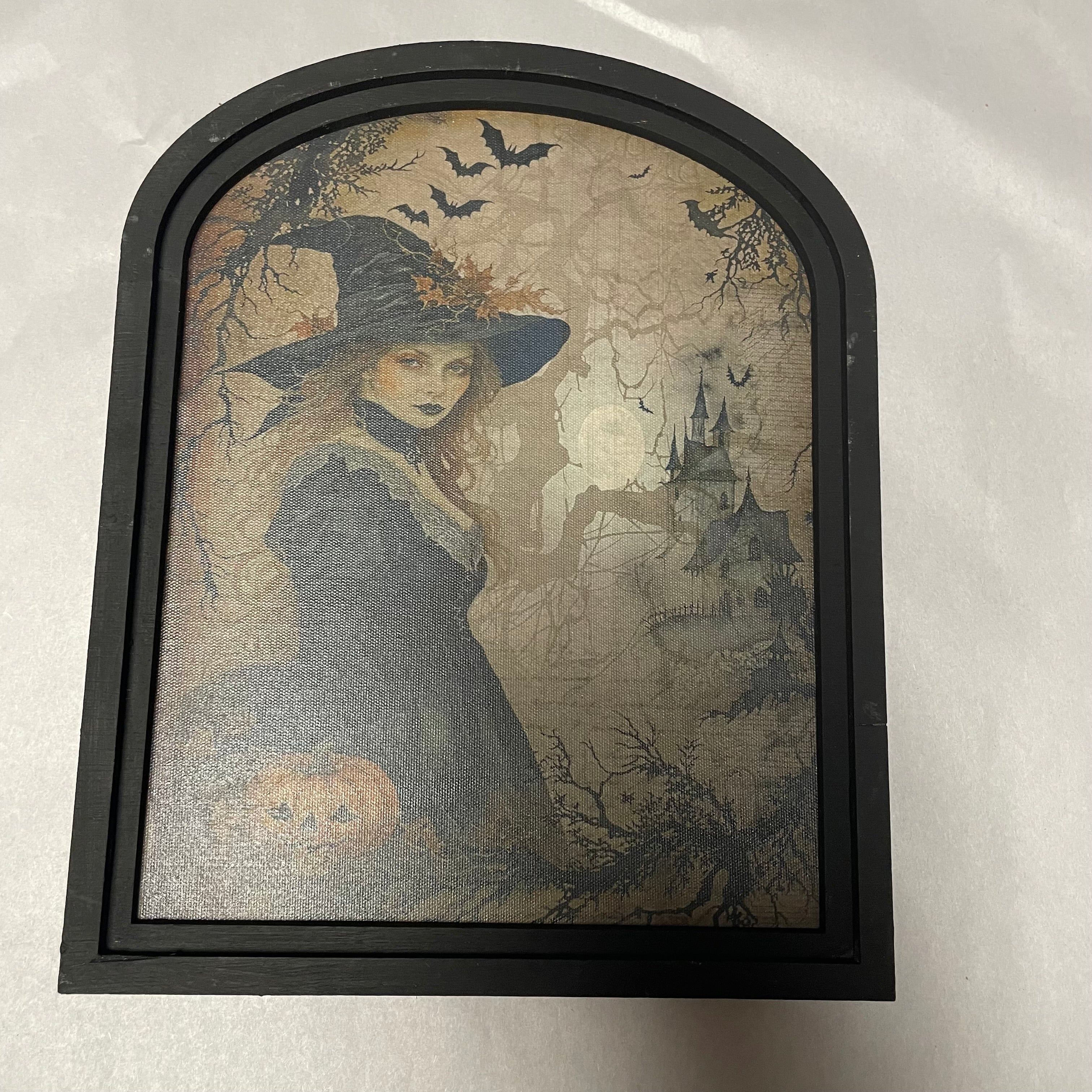 Witch in forest with castle canvas print in small arch