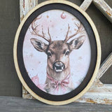Deer with pink bow framed in oval frame