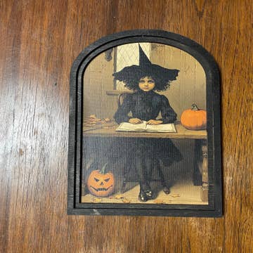 Witch behind desk at Academy in Small Arch Frame
