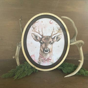 Deer with pink bow framed in oval frame