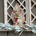 Santa Holding Basket of Toys with Girl Holding Doll Stand up