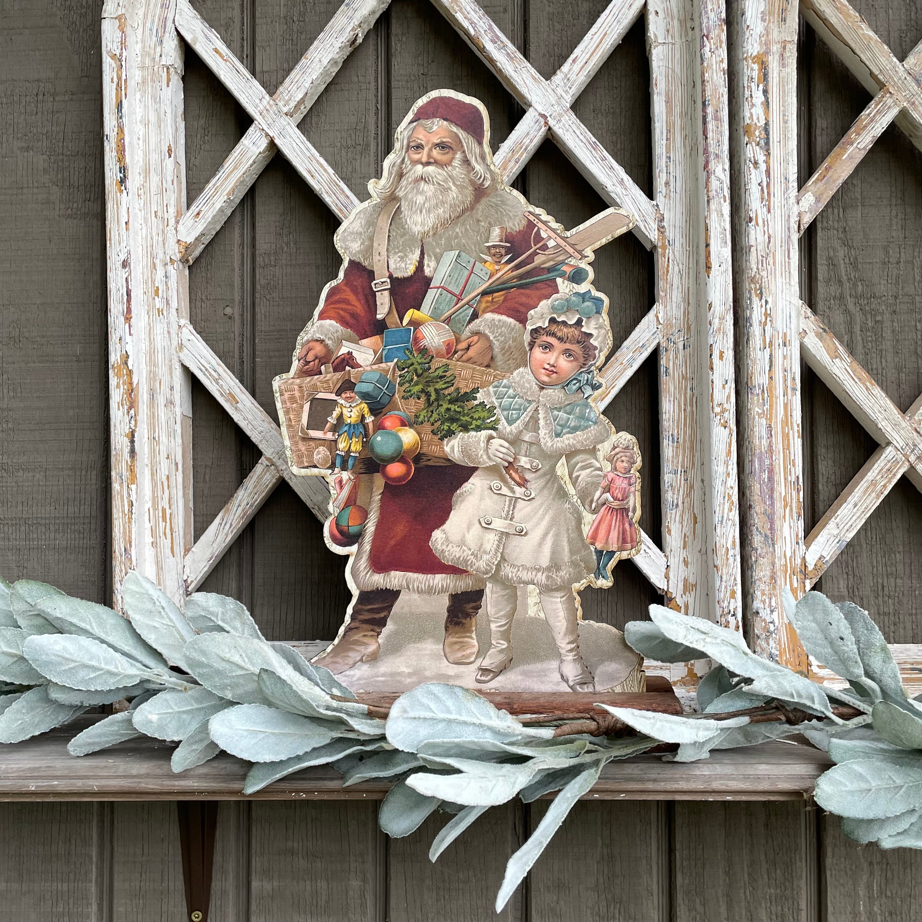 Santa Holding Basket of Toys with Girl Holding Doll Stand up