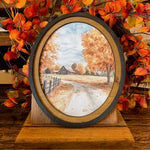 Autumn Barn with county road canvas print in oval frame