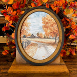 Autumn Barn with county road canvas print in oval frame
