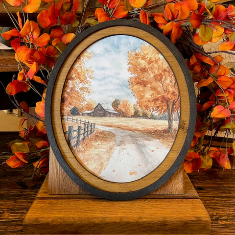 Autumn Barn with county road canvas print in oval frame