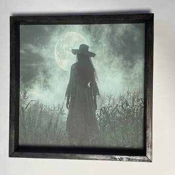 WITCH LOOKING AT MOON FRAMED PRINT