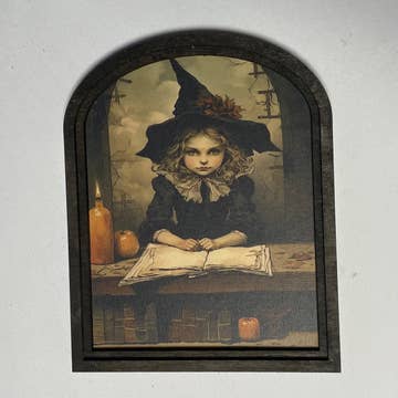 Witch behind desk at Academy w/ Candles in Small Arch Frame