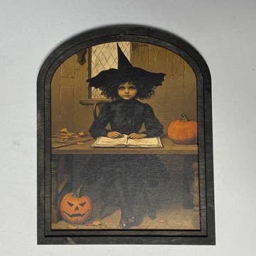 Witch behind desk at Academy in Small Arch Frame